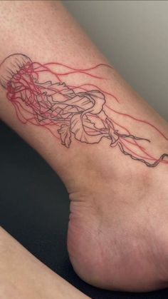 a woman's foot with a jelly tattoo on it