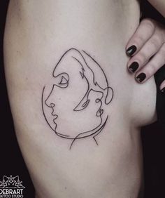 a woman's thigh with a line drawing of a face on the side of her leg