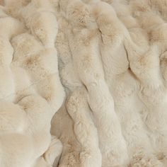 a close up view of the fur on a sheepskin bed spread with no sheets