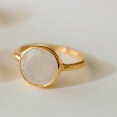 Stunning and cool moonstone ring in sterling silver with 18k gold plate. The center moonstone measures aprox. 11mm in diameter.Choose from size 5, 6, 7, or 8.This is such a chic and elegant style! Just wearing it makes one feel so zen and calm, protected and feminine too.Moonstones have always been associated with peace, femininity, intuition, balance, success and good fortune, and inspiration. Also great stones for inner strength and new beginnings. *Please note that due to the natural nature o Modern Gold Moonstone Rings, Everyday Gold Moonstone Rings, Minimalist Gold Moonstone Ring, Elegant Gold Moonstone Moon Ring, Elegant Gold Moon-shaped Moonstone Ring, Elegant Round Moonstone Ring For Everyday, Elegant Moonstone Open Ring With Moon Phase, Elegant Round Moonstone Ring With Moon Phase, Elegant White Moon Phase Ring