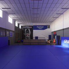 an indoor gym with blue flooring and white walls