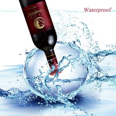 a bottle of wine is in the water with splashing around it and on top of an ornament