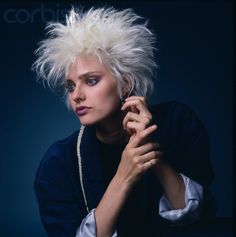 a woman with white hair posing for a photo