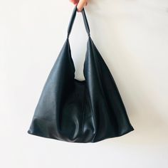 This bag has modern design and is really functional. It can be used as Vegan Leather plait Tote Bag, Leather Slouchy Bag, Hobo Bag, Shoulder Bag, Outside Bag, Large handbag, Shopping Bag for Women, Girl. This tote bag is extremely light, the leather is ultra soft. The bag can be used for work, school, shopping, holiday and traveling, and can put all your needs in daily life. Premium Quality vegan Leather Tote Bag which is Environmentally friendly materials. Size: 19.68 inch (50cm) on the top wid Modern Square Hobo Bag For Everyday Use, Everyday Softback Shoulder Bag In Soft Leather, Daily Use Soft Leather Softback Bag, Everyday Minimalist Shoulder Bag With Large Capacity, Minimalist Daily Shoulder Bag With Large Capacity, Modern Leather Softback Shoulder Bag, Modern Everyday Softback Bag, Soft Leather Softback Bags For Everyday Use, Softback Soft Leather Bags For Everyday Use