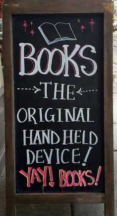 a sign that says books the original hand - held device, why books? on it