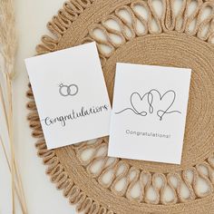 two congratulations cards on top of a doily