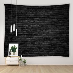 a black brick wall hanging over a wooden floor