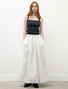 This voluminous skirt features slits at the narrow of the waist and cascades outwards with gathered pleating to finish below the knee. it features an elasticized waist with a toggle cinch and large pockets at the sides of the garment. its crisp cotton has a faded off white finish and a beautiful stone washed hand.    - made in the netherlands  - 100% cotton  - dry clean only  - hanna is 5’9”; bust 31.5” waist 25”; hips 35: wears a size small Voluminous Skirt, Simple Skirt, Designer Outfits Woman, Long Skirt, The Netherlands, The Knee, Netherlands, Dry Clean, Off White