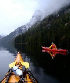 a person in a kayak paddling on the water