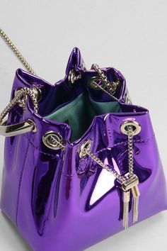 Bon Bon Hand bag in Viola leather, Width 140 mm, Height 150 mm, ring handle, chain shoulder strap, coulisse closure, liquid metal leather, gold hardware, Made in Italy | Jimmy Choo Women's Bon Bon Hand Bag in Viola Leather in Purple | FW23/24 Dope Clothes, Liquid Metal, Ring Handle, Bon Bon, Footwear Design Women, Dope Outfits, Luxury Retail, Hand Bag, Luxury Boutique