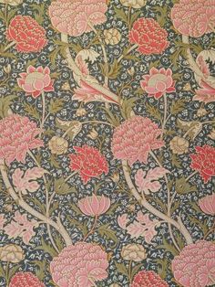 an intricately designed wallpaper with pink flowers and leaves on blue ground, in the middle