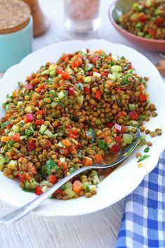 a white plate topped with lentils and carrots