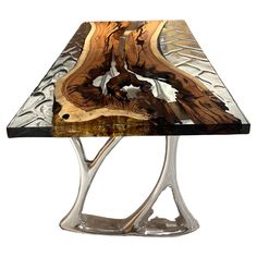 a glass table with metal legs and wood inlays on it's sides