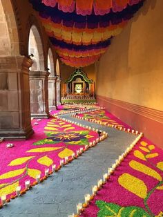 colorful carpet covering the floor in an ornate room with columns and arches on either side