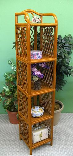 a wooden shelf with baskets on top of it in front of a potted plant