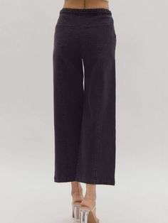 Elevate your style with our versatile and sophisticated high-waisted wide-leg pants. These solid black bottoms feature a unique braided detail at the waist, adding a touch of elegance to a timeless silhouette. The button and zipper closure ensures a secure fit, while the lightweight, woven fabric offers comfort and effortless movement. Designed for versatility, these pants are non-sheer and unlined, making them the perfect choice for both day and night. Pair with your favorite blouse or top for