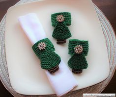 two green crocheted items on top of a white plate