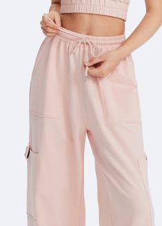 Embrace roomy wide legs and a stretchy fit for ultimate comfort, paired with a flattering high waist for added style. Whether it's grocery runs, lazy Sundays, or a casual hangout, these joggers have you covered in relaxed elegance. Pink Relaxed Fit Wide-leg Sweatpants, Pink Wide-leg Relaxed Fit Sweatpants, Casual Pink Wide Leg Pants For Loungewear, Pink Wide Leg Pants With Elastic Waistband For Loungewear, Comfortable Wide Leg Pants With Drawstring, Parachute Pants With Cargo Pockets For Loungewear, Spring Loungewear Sweatpants With Cargo Pockets, Baggy Athleisure Bottoms With Drawstring, Baggy Drawstring Bottoms For Athleisure