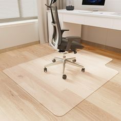 an office chair sitting on top of a hard wood floor next to a computer desk