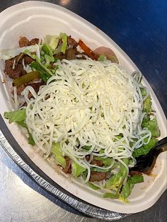 a salad with noodles and meat in a plastic container