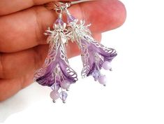 Gorgeous and delicate hand-painted lavender flower earrings. A unique statement accessory for any dress occasion. A beautiful bridal or bridesmaid accessory for the spring garden wedding. These blooms feature Lucite ruffled orchid flowers hand-dyed with light purple and lavender color blend dressed in fancy lacy silver-plated brass filigree wraps and adorned with layers of silver-plated leaf caps topped with sparkling glass crystals.  Mimicking the stamen are glass crystal beads and lavender Amethyst.  The total length from the top of the silver-plated lever back style ear wires is 2.25" (6.2 cm). The wires are lead and nickel free suitable for sensitive ears and allergy-safe. The earrings will be shipped gift-wrapped in tissue paper and an organza bag perfect for gifting and safekeeping. Elegant Purple Summer Jewelry, Elegant Purple Jewelry For Summer, Elegant Summer Purple Jewelry, Elegant Lavender Flower Earrings For Gift, Elegant Purple Flower Earrings, Elegant Purple Flower Shaped Earrings, Elegant Purple Sterling Silver Flower Earrings, Elegant Summer Wire Wrapped Earrings, Elegant Wire Wrapped Earrings For Summer