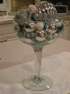 a glass bowl filled with ornaments on top of a counter next to a stovetop