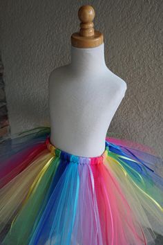 a white mannequin with multi colored tulle