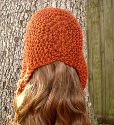 "Style: Chunky earflap hat with tassels for women. Color: This sample hat is shown in Spice, a burnt orange. Sizes: One size fits average teen or adult head size of 20\" to 23\" (50.5 cm to 58 cm). Fiber Content: 80% acrylic, 20% Wool Characteristics: Chunky, very soft, warm and cozy. Care Instructions: Hand wash, dry flat. Every item from Pixiebell is handmade and knit or crocheted to order, unless otherwise stated in title of the item as \"ready to ship\". Production time may vary, please chec Warm Yarn Crochet Hat With Ear Flaps, Hat With Tassels, Flap Hat, Earflap Hat, Chunky Knit Hat, Ear Flap Hats, Womens Hat, Knitted Hood, Skull Cap Beanie