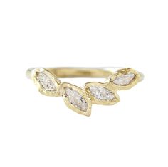 a gold ring with three pear shaped diamonds