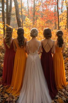 four bridesmaids standing in the woods with their back to the camera, looking at leaves