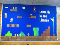 an image of a game on the wall in a school room that says level up in the library