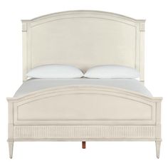 a white bed with two pillows on top of it's headboard and foot board