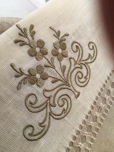 an embroidered piece of cloth with flowers on it