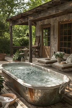 an outdoor hot tub sitting on top of a wooden deck