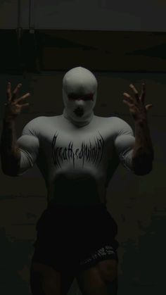 a man in a white body suit with his hands out