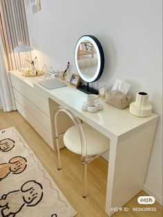 a white desk with a mirror on top of it and a rug in front of it