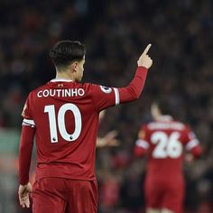 a soccer player giving the finger up to his team mate