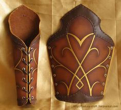 two brown leather vases sitting next to each other on top of a cloth covered surface