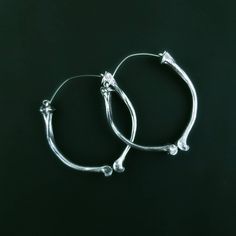 "Lead-free pewter cast chicken bone hoops. Tunnel friendly hoops but can also be worn in regular pierced ears. Hoops are 2\" x 2\" Standard free US shipping is USPS First Class. Standard free shipping includes up to $100 insurance with an upgrade option for an additional $100 covering the actual cost of the items. For orders over $200, message us for additional insurance. Upgrade option for USPS Priority is available. We will refund any shipping overages. International shipping is set for USPS F Handmade Metal Jewelry In Bone Color, Bone Colored Metal Earrings For Pierced Ears, Unique Metal Hypoallergenic Hoop Earrings, Unique Hypoallergenic Metal Hoop Earrings, Hypoallergenic Silver Hoop Earrings In Brass, Unique Bone-colored Metal Jewelry, Tunnel Earrings, Chicken Bones, Earrings Hoops