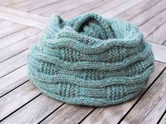 a knitted hat sitting on top of a wooden floor