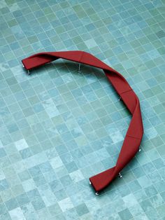 a curved piece of cloth on the ground in front of a tiled floor with blue tiles