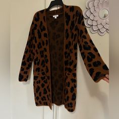 Nine West Size Small Leopard Print Never Worn Acrylic, Nylon Blend Long-Length Cardigan Front Pockets Trendy Long Brown Cardigan, Trendy Brown Cardigan For Layering, Trendy Brown Open Front Cardigan, Casual Leopard Print Outerwear For Layering, Long Brown Sweater For Fall, Trendy Brown Open Front Sweater, Long Brown Spring Sweater, Brown Open Front Sweater For Layering, Brown Open Front Layering Sweater