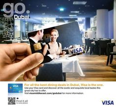 a person holding up a visa card in front of a restaurant