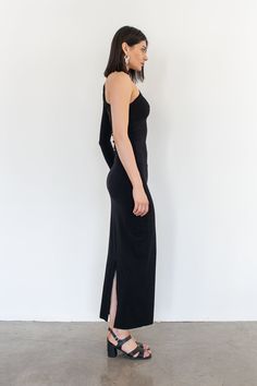 Our newest basic, the Jessi dress is a one armed fitted silhouette featuring a fold over chest detail and the length hitting at the ankle. Black - 90% Viscose / 10% Spandex Sleeve is on right side. Hand wash only and lay flat too dry. Cris is 5'9 / 175 cm and wearing a size 1 which is equivalent to a size small. Sleek Fitted Sleeveless Maxi Dress, Fitted One-shoulder Casual Dress, Fitted One-shoulder Maxi Dress, Fitted One Shoulder Maxi Dress, One Shoulder Stretch Maxi Dress With Side Slits, Stretch One-shoulder Maxi Dress With Side Slits, One-shoulder Stretch Dress With Side Slits, One Shoulder Stretch Dress With Side Slits, Fitted Midi Dress With Side Slits For Casual Wear