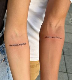 two people standing next to each other with tattoos on their arms that say, always and forever