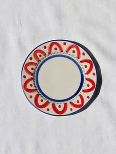 a red, white and blue plate sitting on top of a tablecloth covered floor