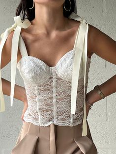 Sensual, glamorous and delicate, meet our Magical Bustier Top. Lace is a must have this season and our bustier with the signature bows is just the piece your closets been missing. PRODUCT DESCRIPTION: Lace top Manual decoration on bust COMPOSITION: French Lace 55% Nylon, 45% Cotton CARE: Hand wash ELABORATED IN: Cali, Colombia, Cauca ValleyThe model is wearing a size XS Lace Bustier Top, Cali Colombia, Lace Bustier, Bustier Top, French Lace, How To Make Bows, Cali, Must Haves, Lace Top