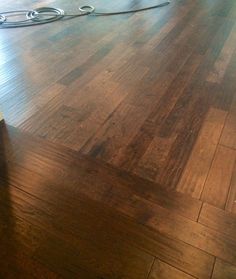 a wooden floor is being worked on by a power washer