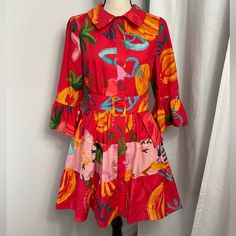 Nwt, Farm Rio Colorful Tiered Mini Dress. Flutter Sleeves Tiered Layers 100% Cotton Tropical Motifs Belt Included Button Front Closure Machine Wash Measurements Are Flat Lay And Approximate Shoulders 14.5in. Bust 19.25in. Waist 17.5in. Length 33.75in. Spring Vacation Red Shirt Dress, Red Shirt Dress For Spring Vacation, Red Cotton Shirt Dress For Spring, Dress Flutter Sleeves, Tropical Motifs, Tiered Mini Dress, Farm Rio, Shirtdress, Tiered Dress