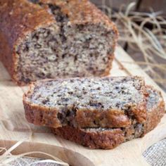 a loaf of banana bread sitting on top of a wooden cutting board